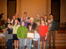 Photo of Mrs. Marie Miller, Distinguished HRS Graduate, with her family and Fr. John