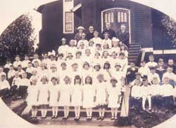 Fr. O'Callaghan with students at Holy Rosary Church on Hanford and California.