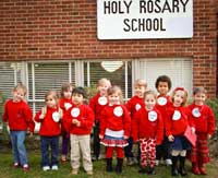 Preschool students in front of the school